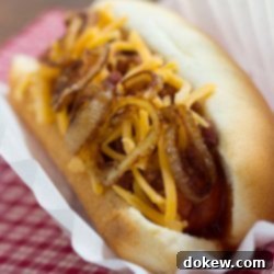 Chuckwagon Hot Dogs 2 hot dog in bun topped with sauteed onion and grated cheddar cheese.