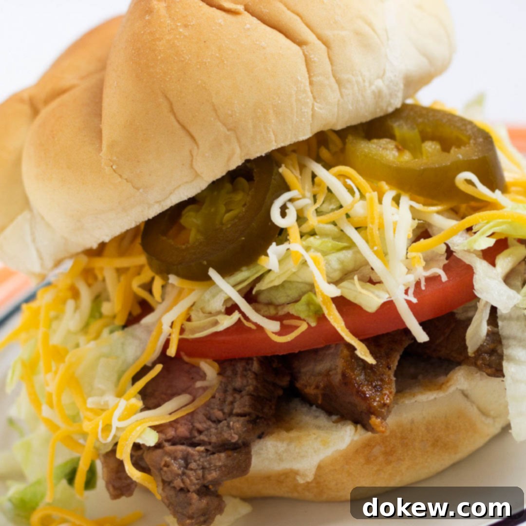 Ultimate Carne Asada Tortas 2 White bun piled with grilled flap meat, lettuce, tomato, cheese, and jalapeno slices