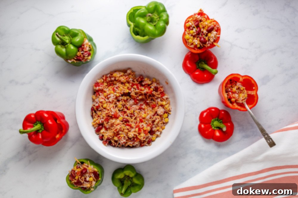 Easy Cheesy Southwestern Stuffed Peppers 5 Bell peppers prepared and filled with the Southwestern mixture, ready to be placed in the slow cooker.