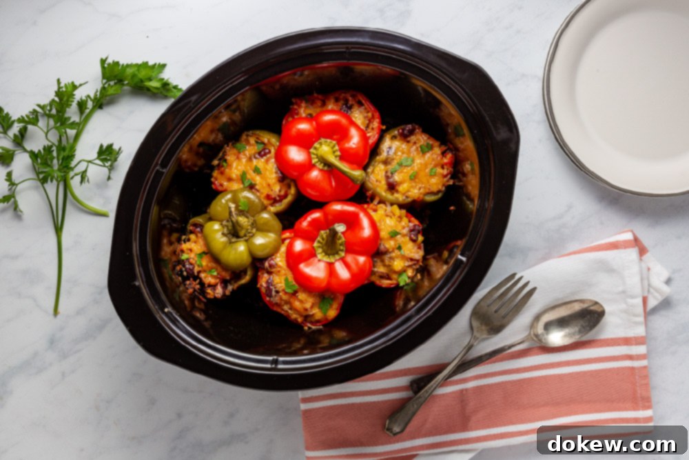 Easy Cheesy Southwestern Stuffed Peppers 7 Finished Easy Slow Cooker Southwestern Stuffed Peppers with Cheese, cooked to perfection and topped with melted golden cheese, ready to serve.