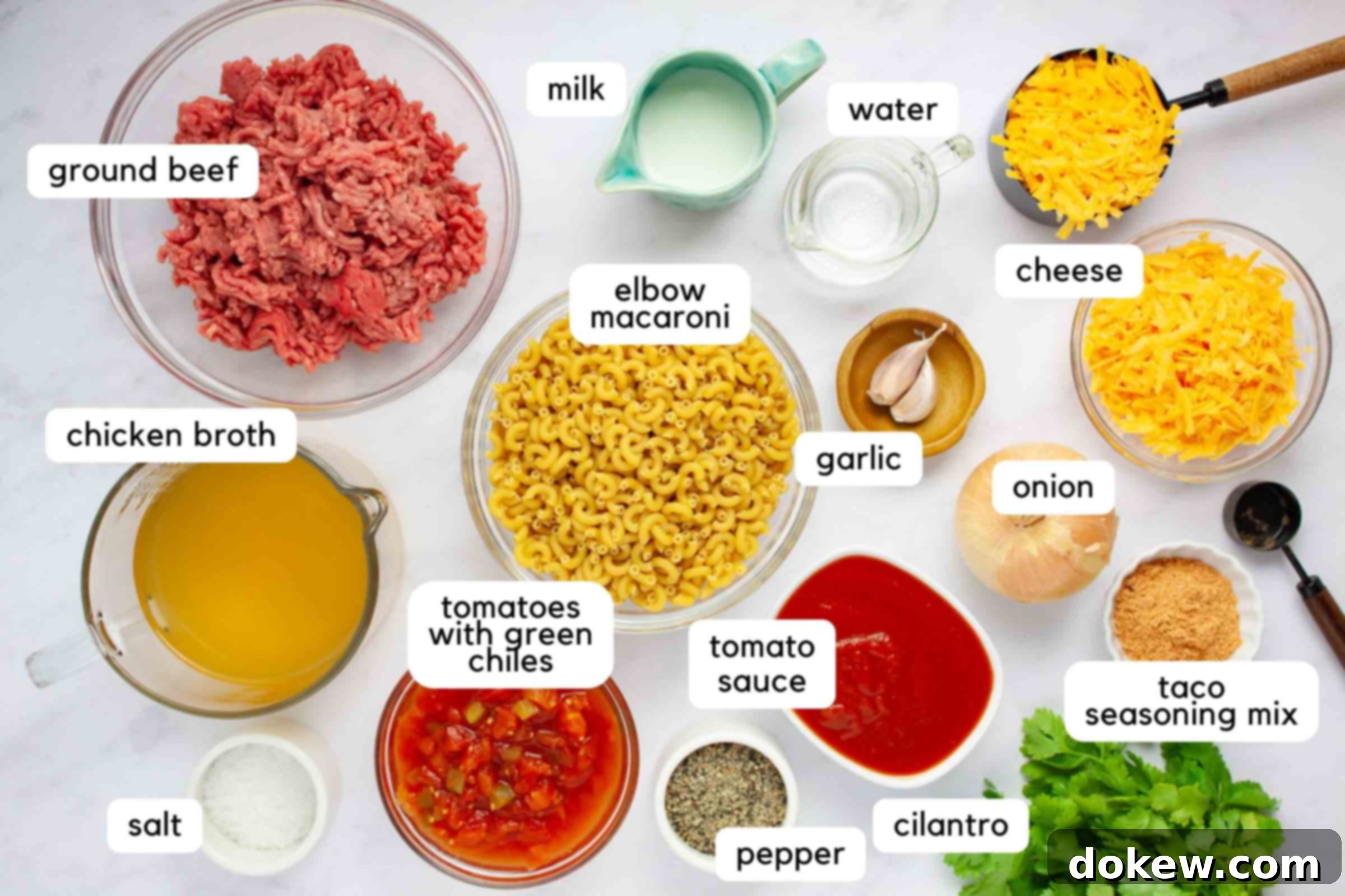 One Pot Taco Macaroni in 30 Minutes 3 Labeled ingredients: ground beef, elbow macaroni, tomatoes with green chiles, tomato sauce, chicken broth, onion, garlic, taco seasoning mix, salt, pepper, shredded cheddar cheese, water, milk, and cilantro.