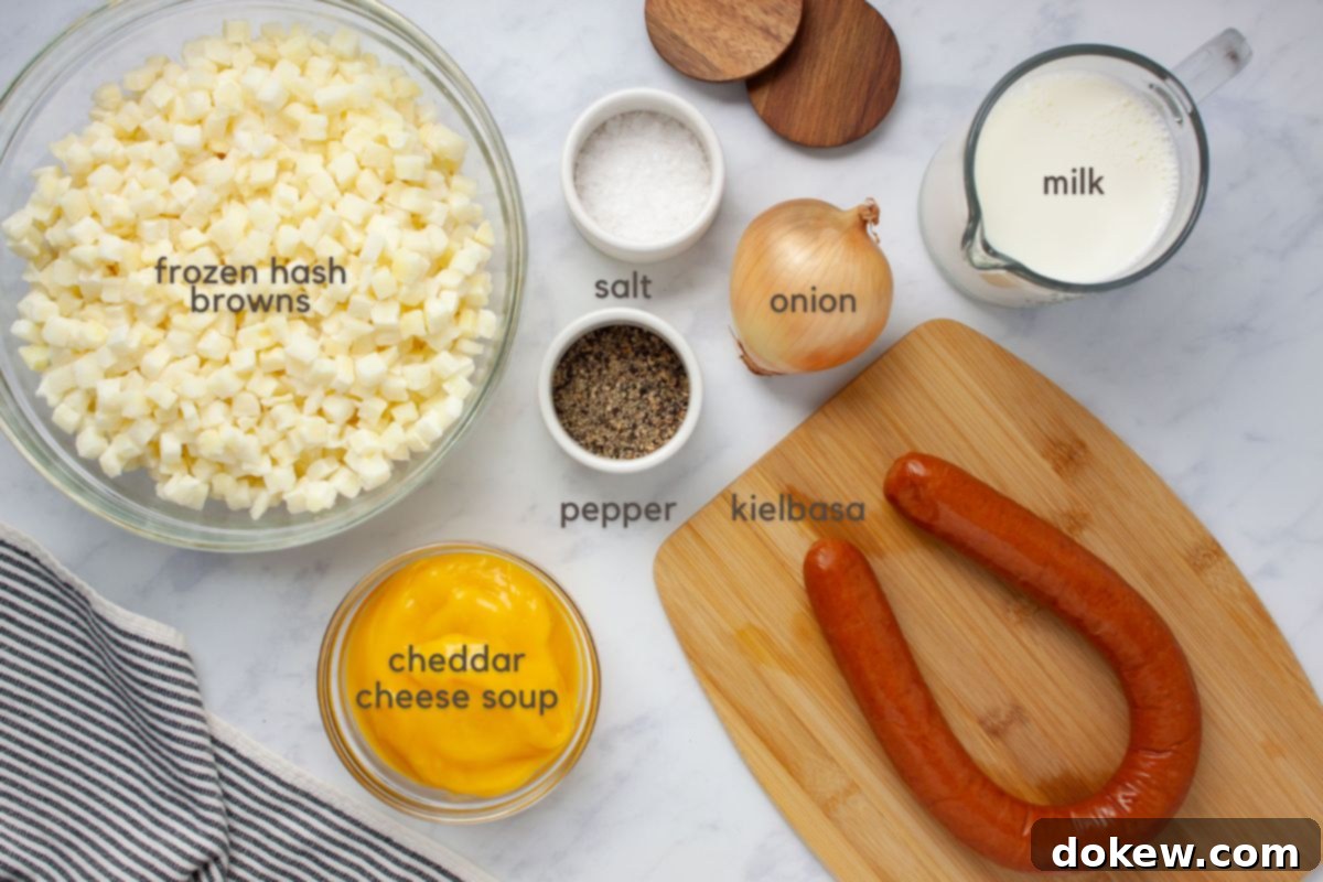 Hearty Cheesy Kielbasa Potato Slow Cooker Soup 3 Labeled ingredients for soup: frozen hash browns, condensed cheddar cheese soup, kielbasa, onion, milk, salt and pepper.