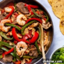 Tex-Mex Fajitas 5 Fajitas Texanas, a vibrant mix of beef, chicken, and shrimp with colorful vegetables, ready for serving.