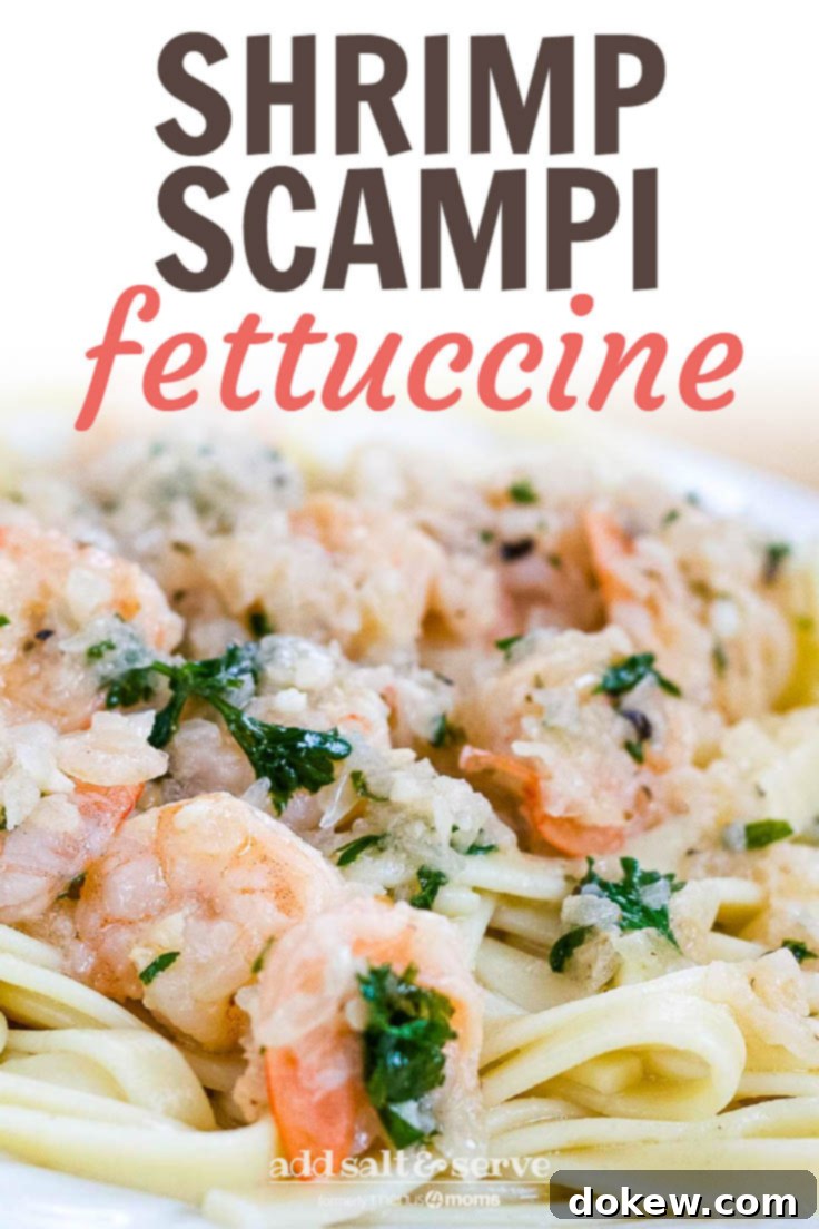 Shrimp Scampi White plate with shrimp, minced garlic, and parsley on a bed of fettuccine