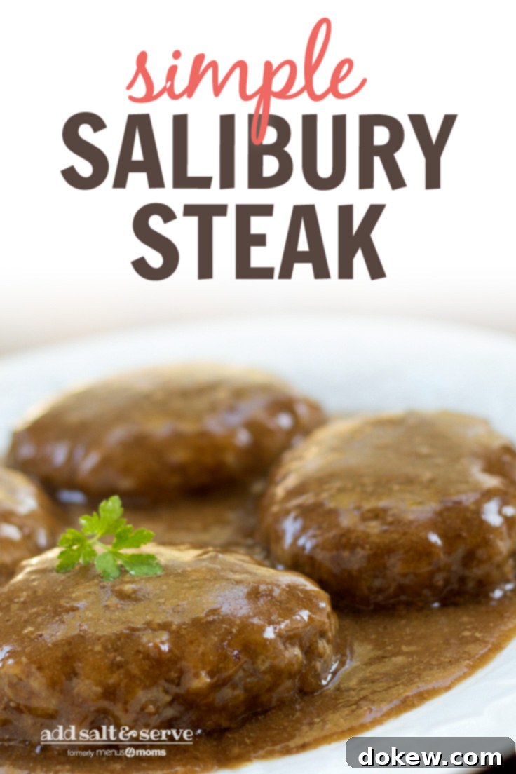 Simple Salisbury Steak Dinner Full plate of Salisbury Steak with gravy and parsley garnish, served with mashed potatoes on the side.