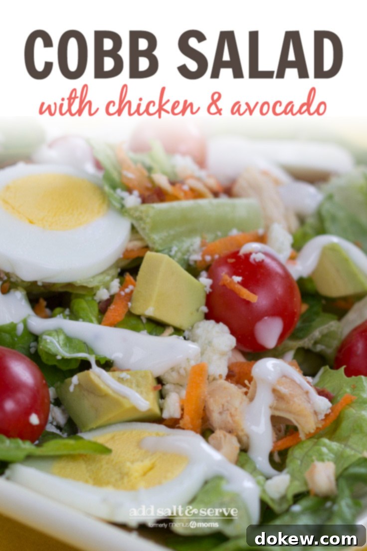 Cobb Salad with Chicken and Avocado in a bowl A vibrant and colorful Cobb Salad, served in a large, inviting bowl. The ingredients are clearly visible: fresh green lettuce, bright red grape tomatoes, perfectly sliced hard-boiled eggs, creamy avocado cubes, tender diced chicken, and crunchy shredded carrots, all ready to be dressed.