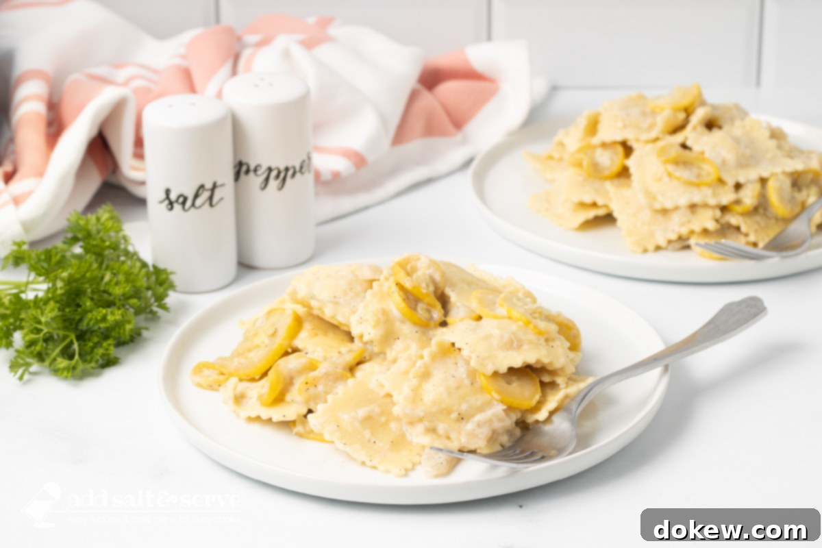 Velvety 20-Minute Summer Squash Ravioli 2 Two plates of Cheese Ravioli with Summer Squash with a creamy sauce with salt and pepper shakers and sprigs of parsley.