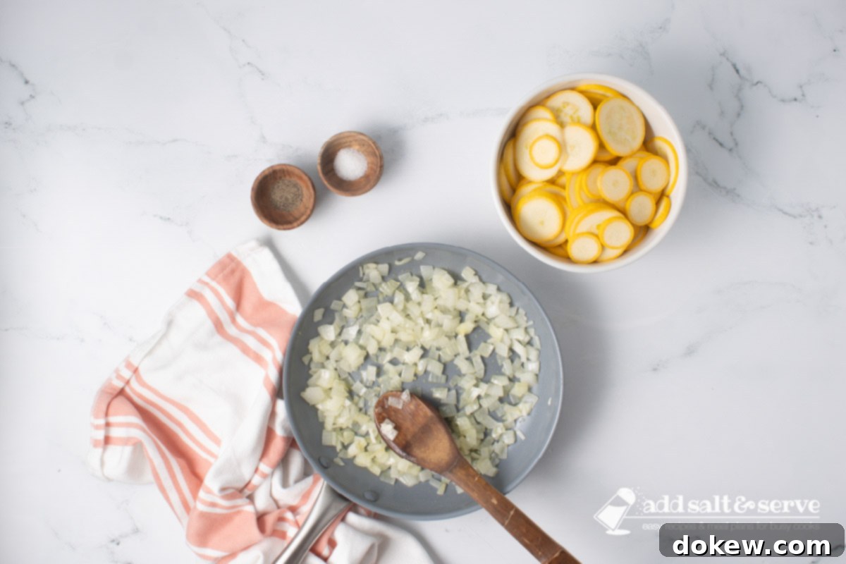 Velvety 20-Minute Summer Squash Ravioli 5 Chopped onion being sautéed in a skillet with a wooden spoon beside a bowl of sliced yellow squash and small bowls of salt and pepper.