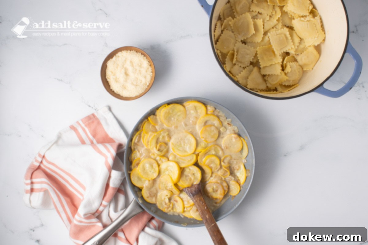 Velvety 20-Minute Summer Squash Ravioli 8 Skillet of sautéed yellow squash and onion after cooking with mixture of milk, flour, and butter beside a pot of cooked cheese ravioli and a small bowl of Parmesan cheese.