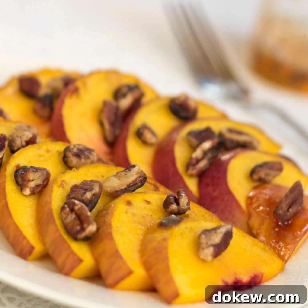 White plate with peach slices topped with chopped pecans, ready to be served as a healthy and easy summer dessert.