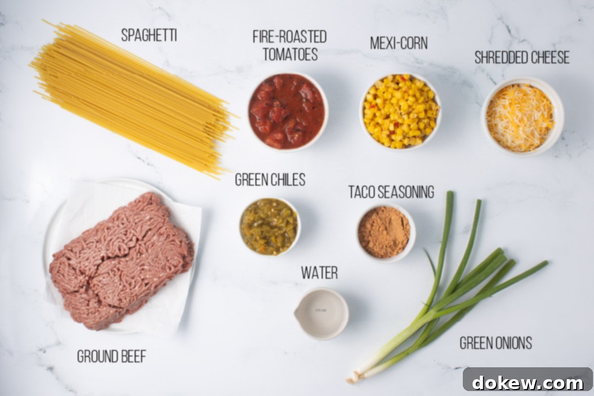 Fiesta Spaghetti 3 A collection of ingredients for Mexican Spaghetti including dry spaghetti, ground beef, green chiles, green onion, Mexi-corn, fire-roasted tomatoes, water, taco seasoning, and shredded cheese.