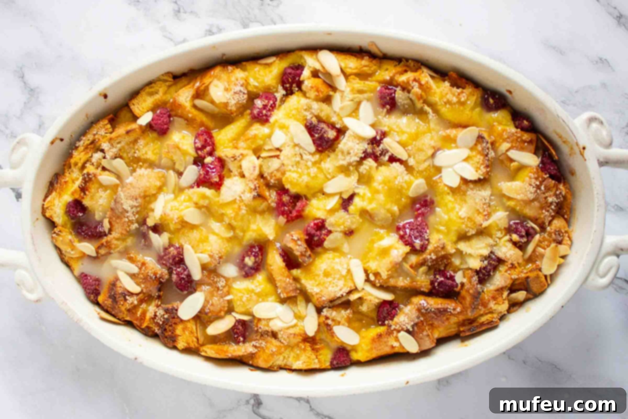 French toast bake with berries and almonds in a casserole dish.